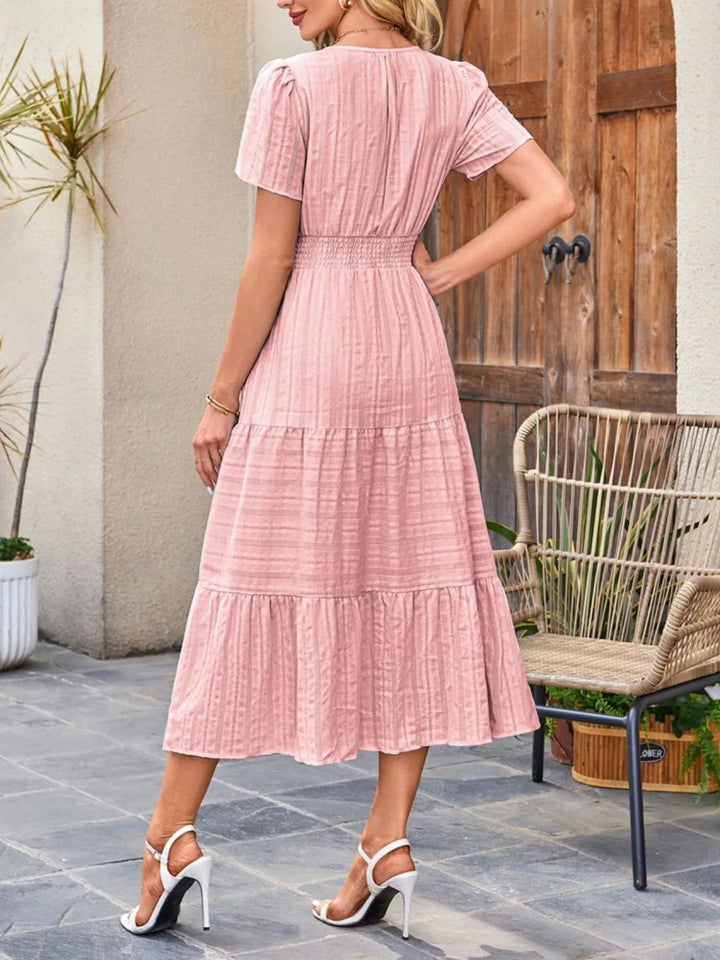 Elegant A-line midi dress featuring a notched neckline & short sleeves.