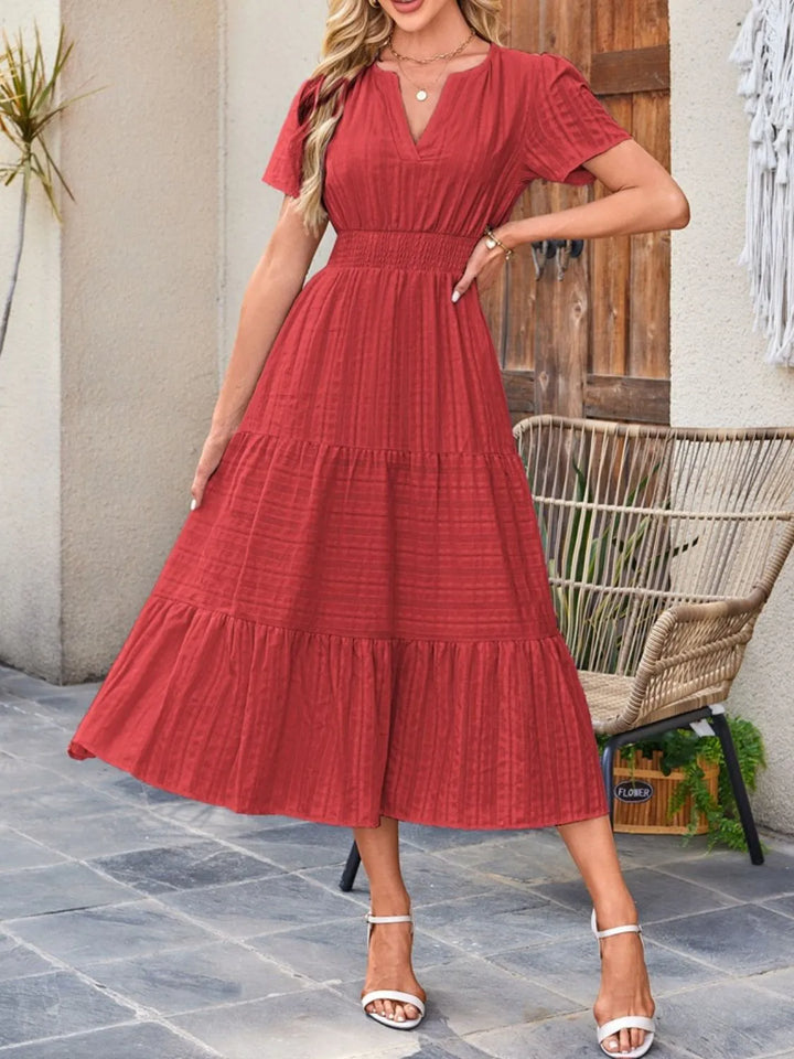Women's short sleeve midi dress with pockets, A-line silhouette, perfect for any occasion.