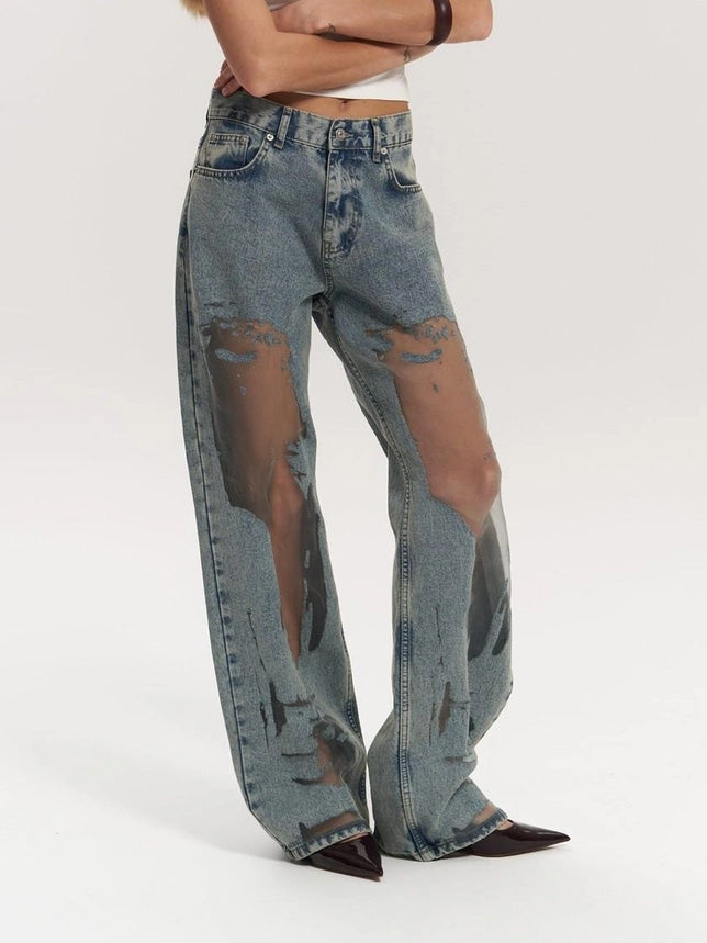 Close-up: trendy women's wide leg jeans, showcasing stylish mesh panel insert & high waist. Denim fashion.