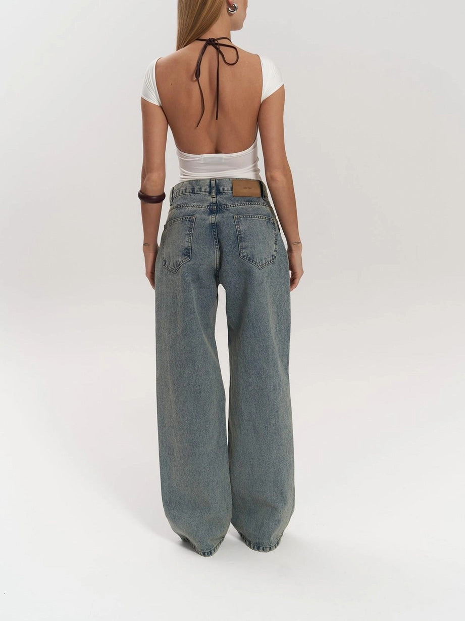 Fashionable women's high waist wide leg jeans in blue denim, featuring a modern mesh panel design for a statement look.