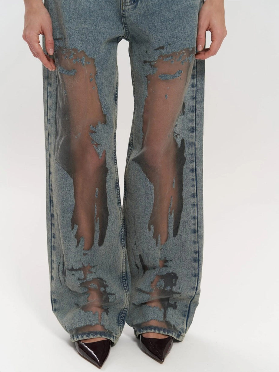 Back view of women's high waist wide leg denim jeans, highlighting unique mesh panel detail and comfortable fit.