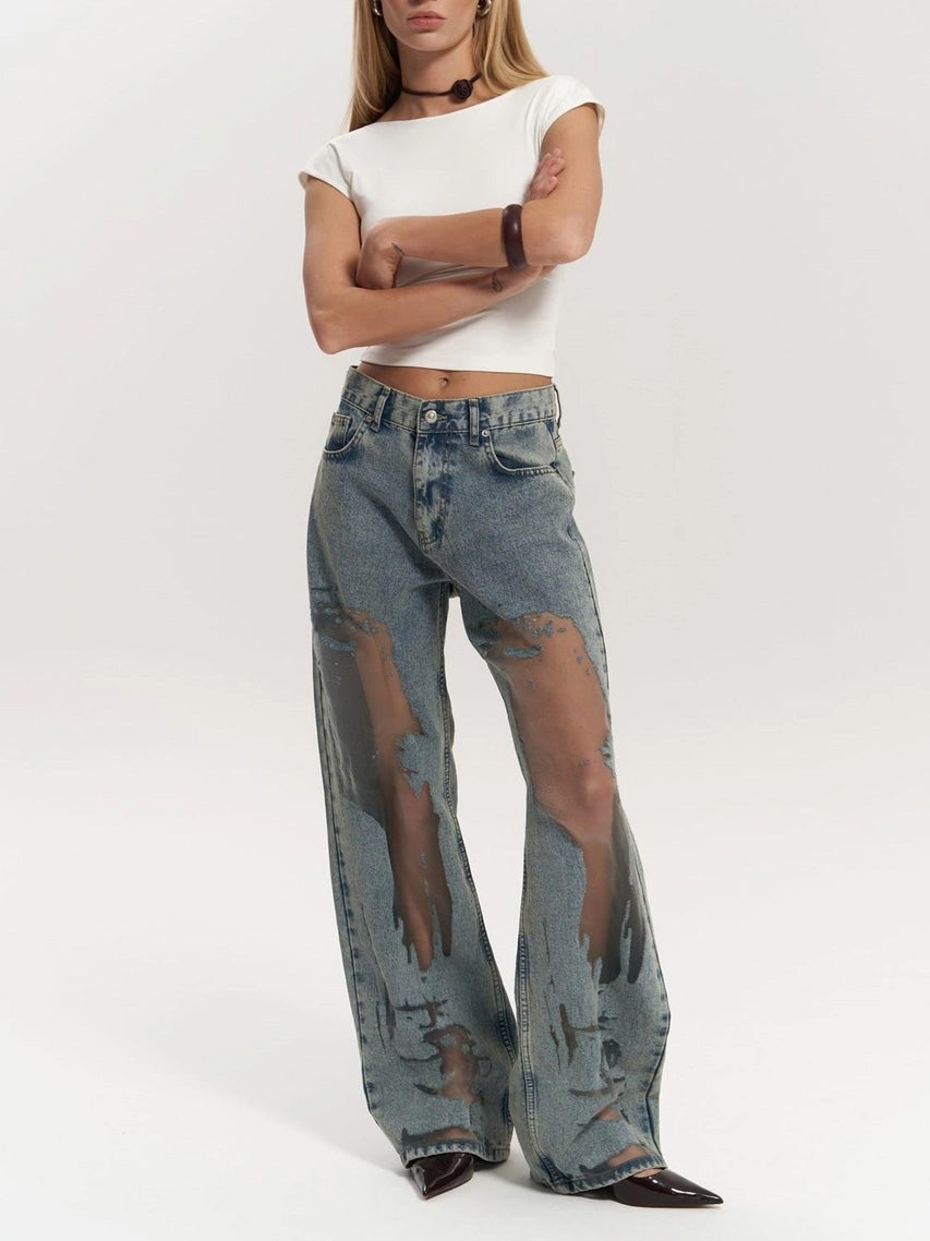 Flat lay: Women's high waist wide leg blue denim jeans with distinctive mesh panel accents, ideal for trendy style.