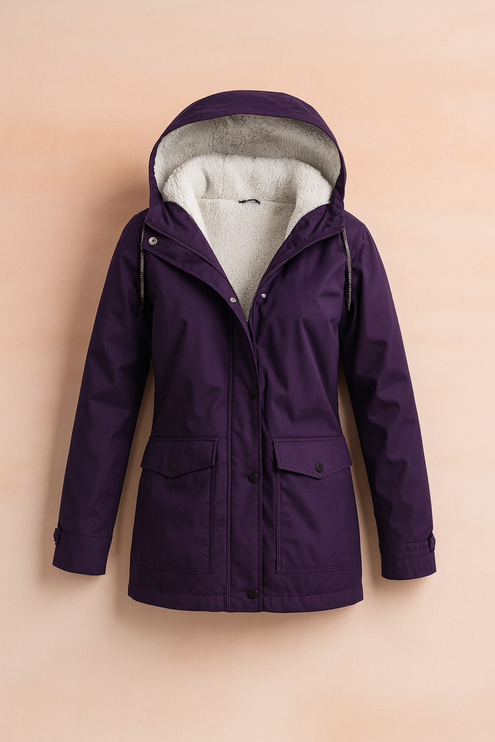 Functional pockets on a women's mid-length utility winter jacket, great for essentials & cold hands.