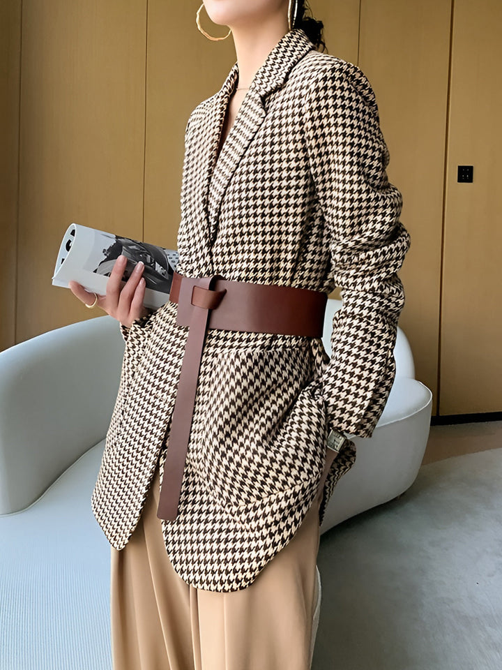 Contemporary women's belted blazer with unique split-hem. Houndstooth pattern, perfect for a chic look.