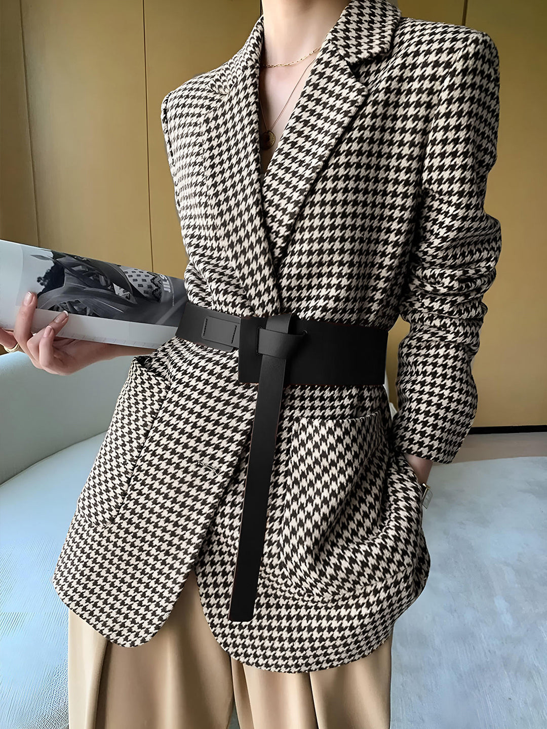 Statement women's houndstooth belted blazer with a split hem. Chic and sophisticated for winter office fashion.