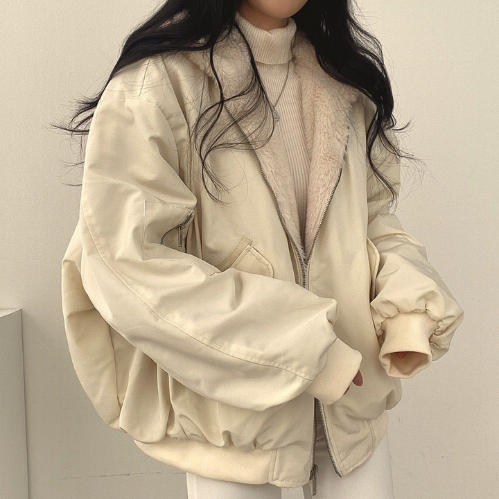 Cozy Isla reversible women's winter jacket, hooded for warmth, perfect versatile outerwear for travel.