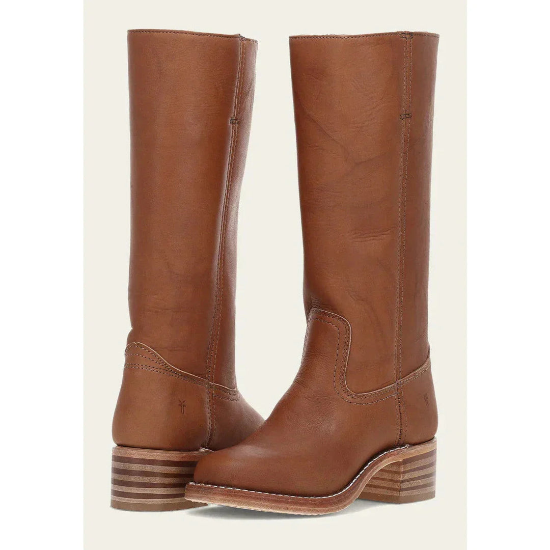 Side view of chic women's knee-high cowboy boots, highlighting the block heel and western silhouette.