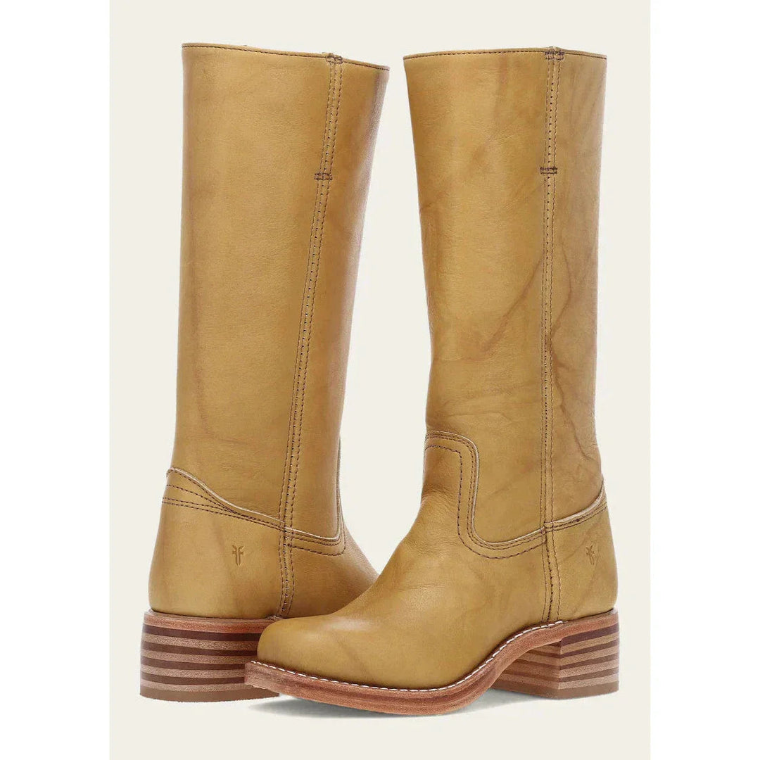 Women's knee-high cowboy boots, completing a stylish western-inspired outfit with tall boot flair.