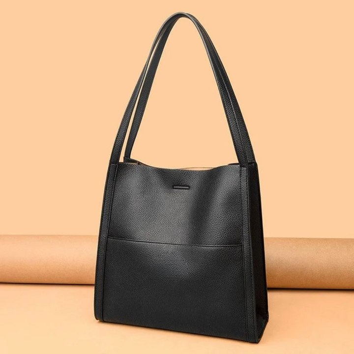 Women's large brown leather tote handbag, spacious for everyday essentials & work.