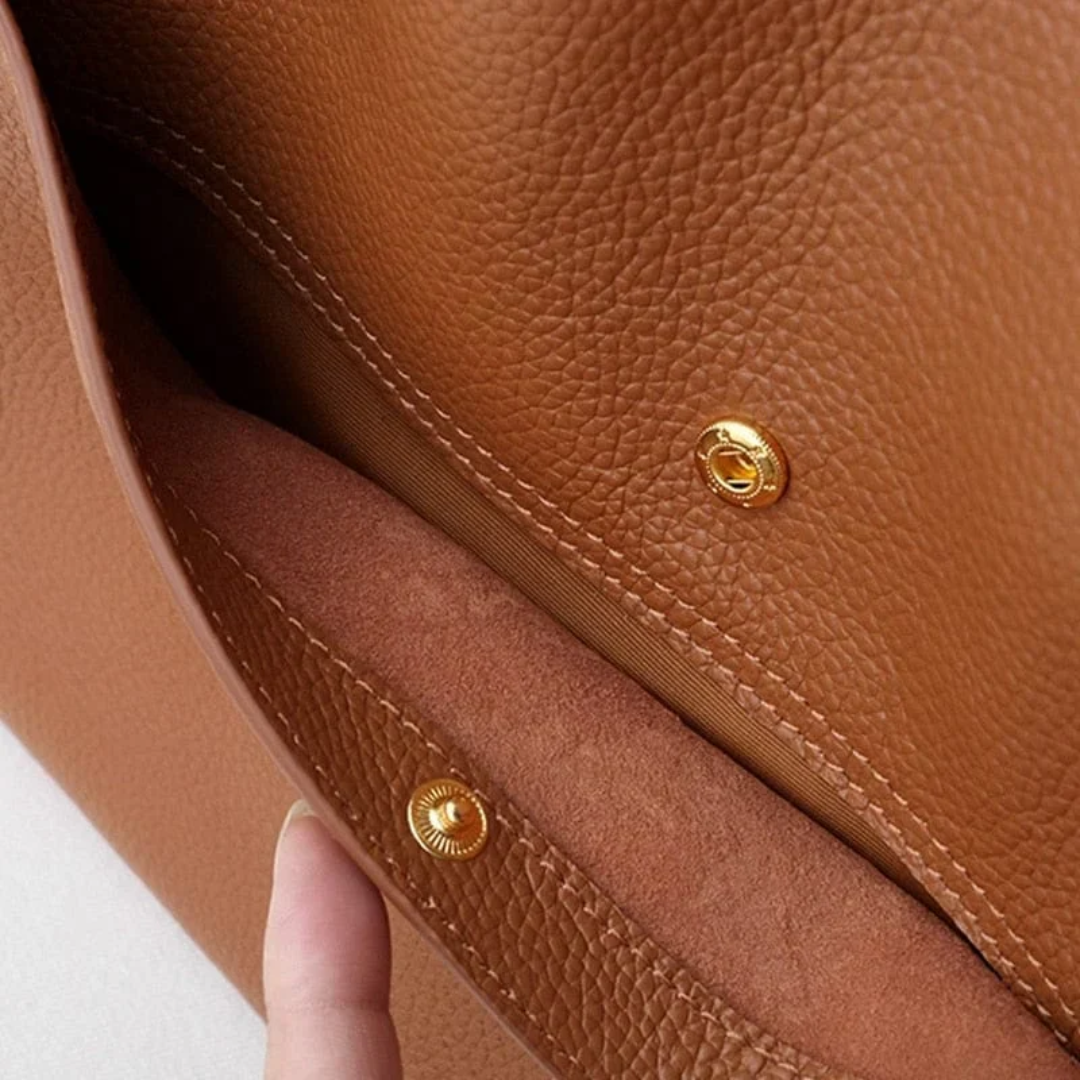 Durable green leather tote handbag for women, large and spacious, ideal for work and travel.