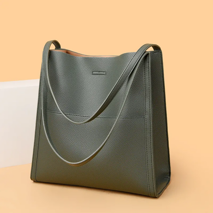 Versatile brown leather tote handbag for women, large capacity, suitable for work or daily errands.