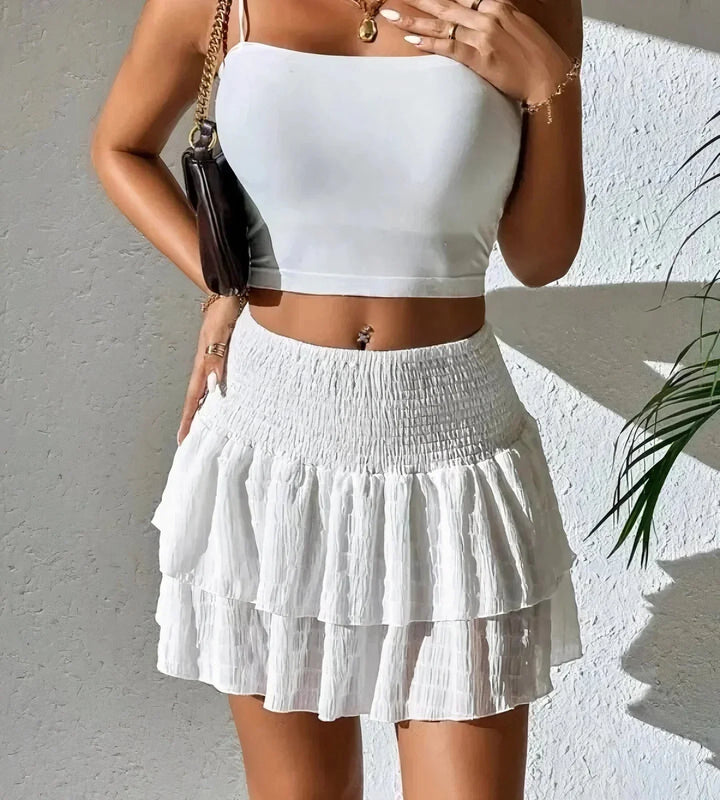 White layered A-line mini skirt. Women's breezy summer style, perfect for casual or vacation looks.
