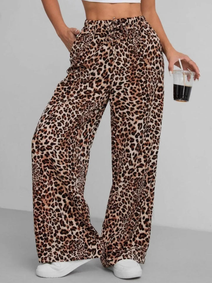 Trendy women's leopard print wide leg pants featuring a comfortable drawstring waist and relaxed fit.