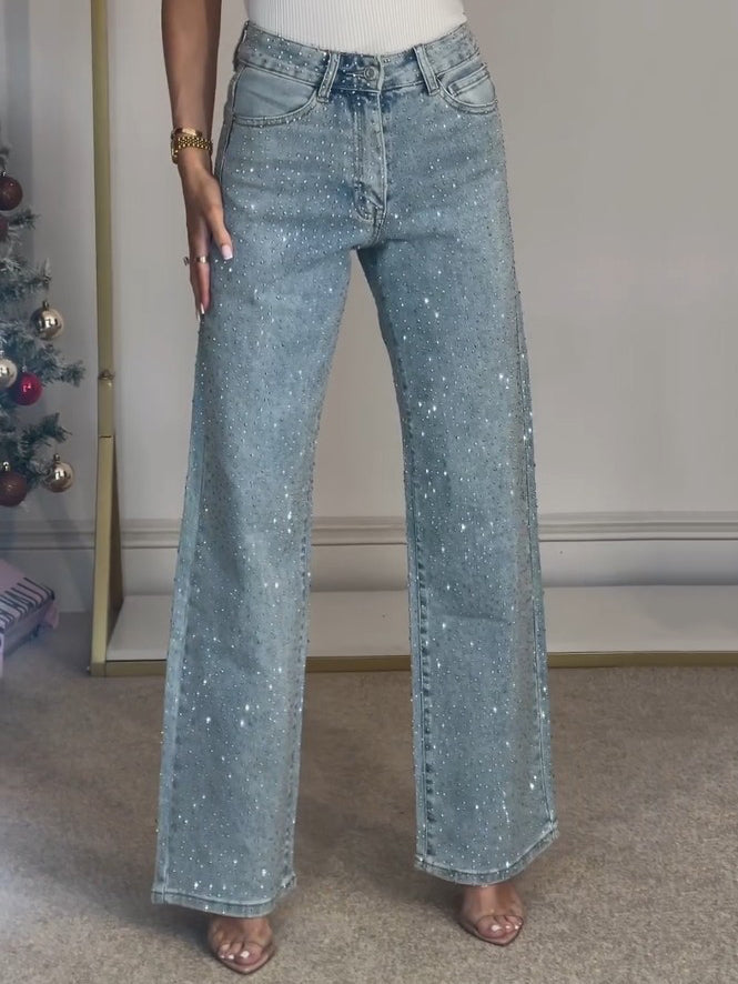 Sparkling women's high waist straight leg jeans, embellished with diamanté detailing for a trendy look.