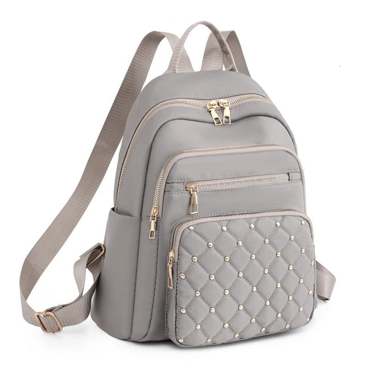 Stylish women's water-resistant nylon backpack, ideal for college, work commutes, or travel.