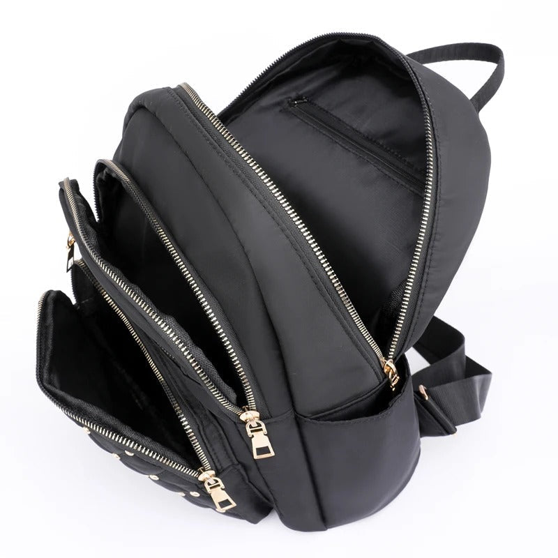 Practical women's lightweight water-resistant nylon backpack, essential for school & travel.