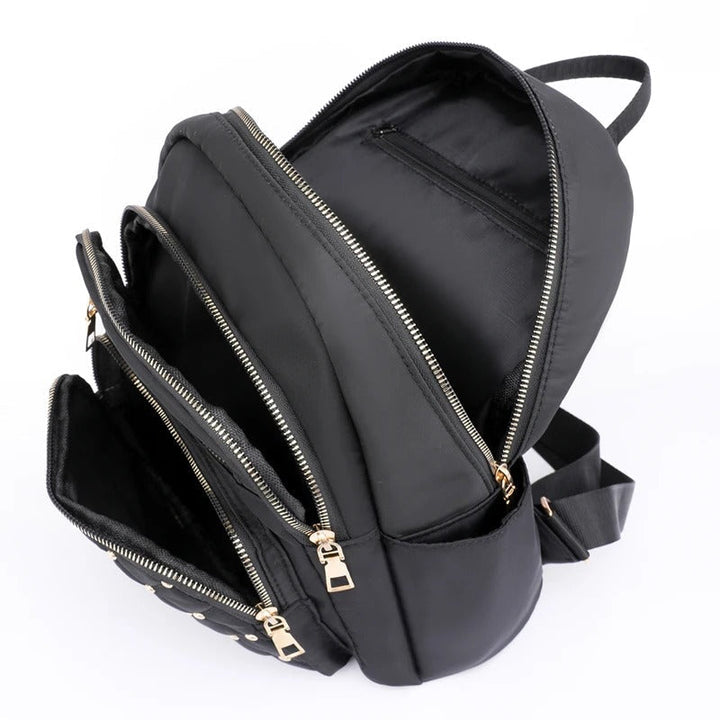 Practical women's lightweight water-resistant nylon backpack, essential for school & travel.