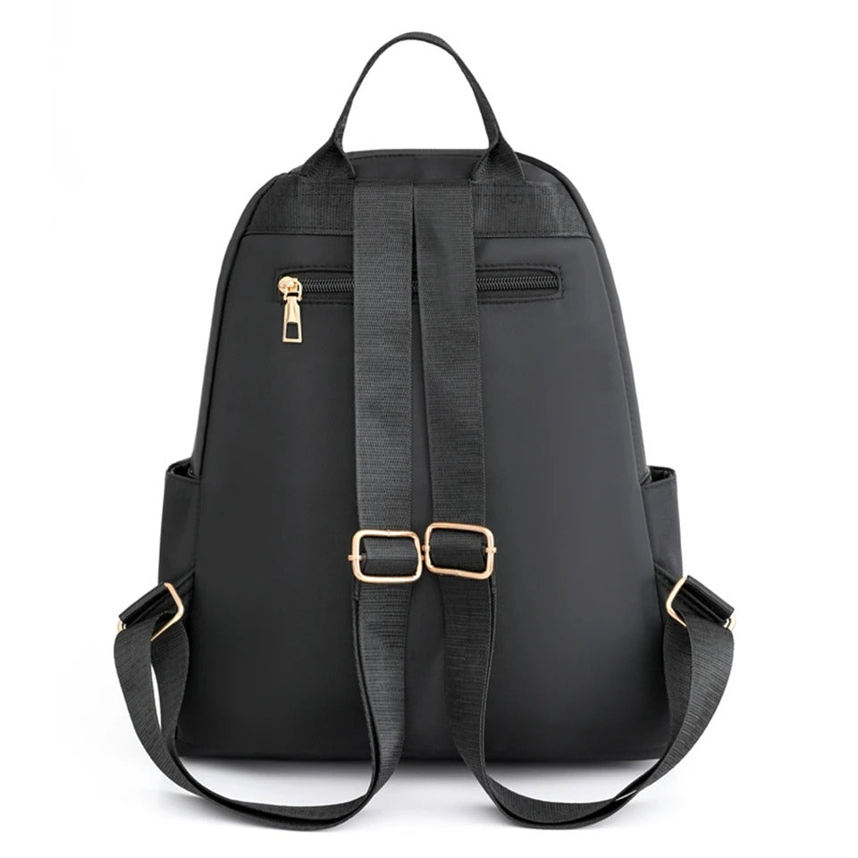 Woman wearing a lightweight nylon water-resistant backpack, perfect for daily errands & commute.