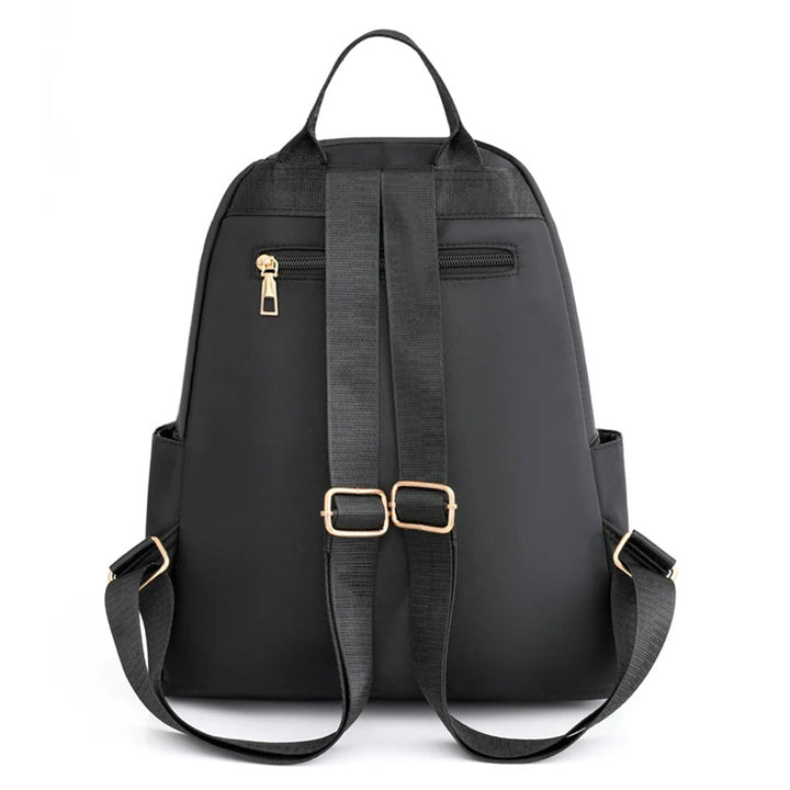 Woman wearing a lightweight nylon water-resistant backpack, perfect for daily errands & commute.