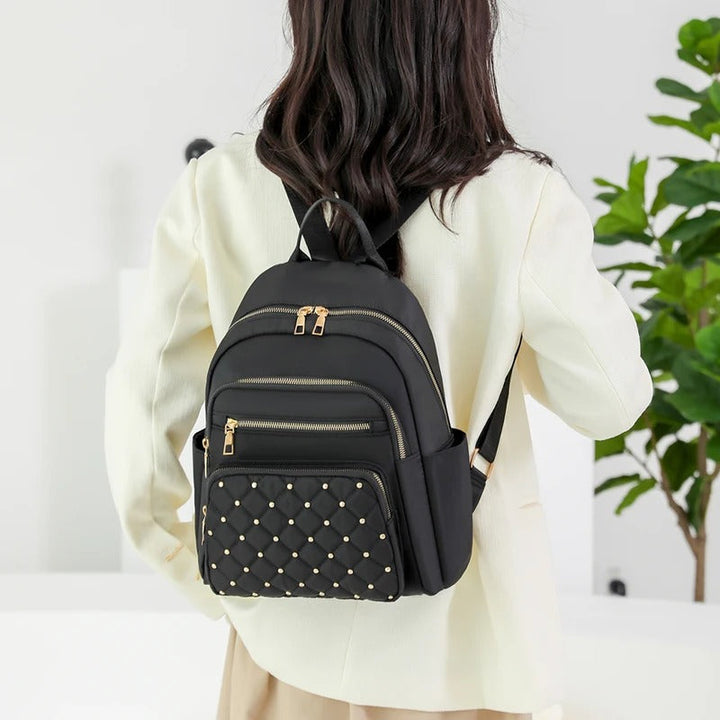 Elegant women's water-resistant shoulder bag. Lightweight nylon backpack for school, work & everyday use.