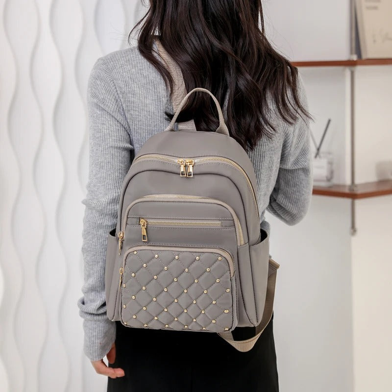High-quality lightweight nylon backpack for women. Water-resistant design for school, travel & daily essentials.