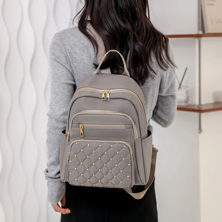High-quality lightweight nylon backpack for women. Water-resistant design for school, travel & daily essentials.