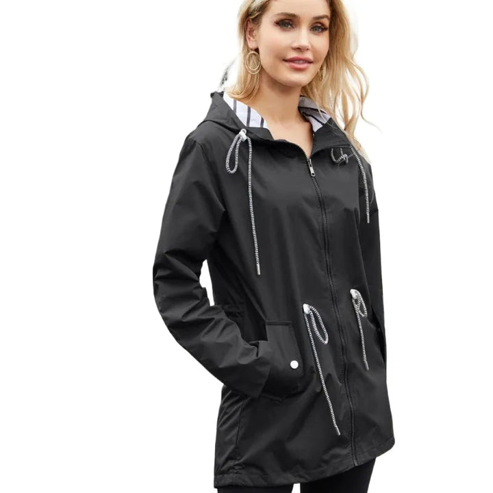 Stylish women's hooded waterproof trench coat. Lightweight rain jacket, ideal for everyday and travel.