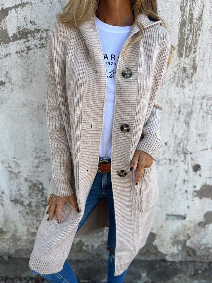 Stylish woman wearing a long knit cardigan with buttons, ideal for casual layering in spring and autumn outfits.