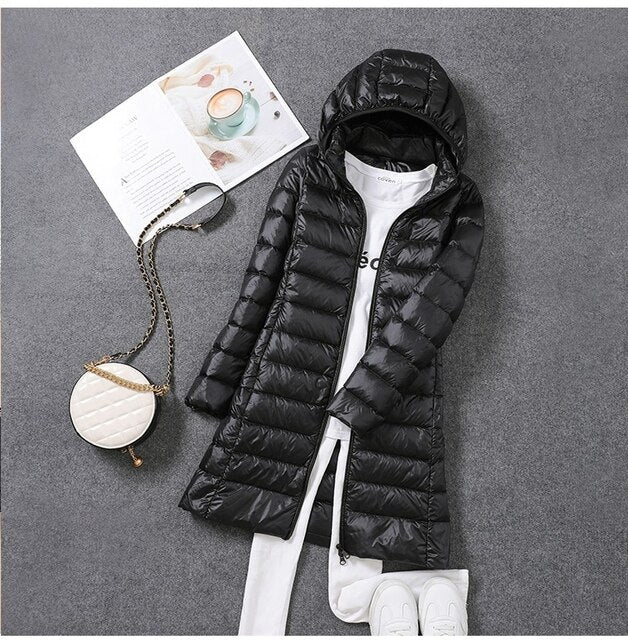 Women's long puffer coat with a practical detachable hood, perfect for versatile winter fashion and warmth.