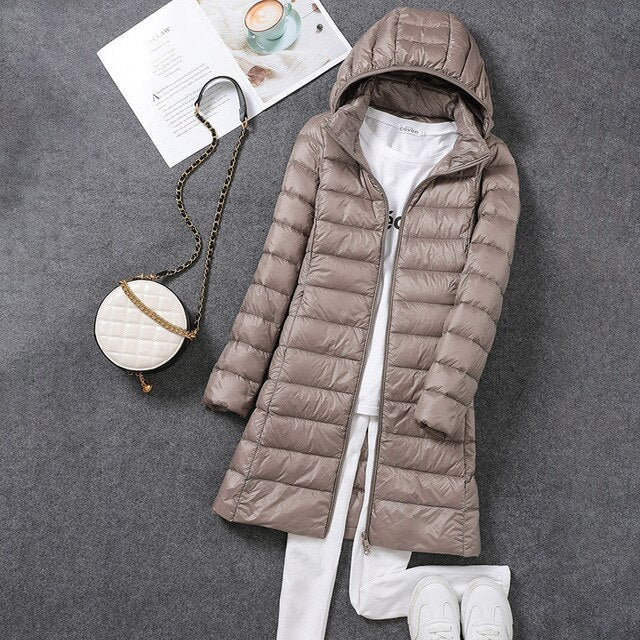 Fashionable women's long puffer outerwear. A warm winter coat with a detachable hood for stylish protection.