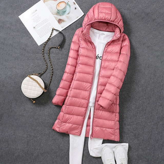 Warm women's long puffer jacket, an essential winter coat for extreme cold, featuring a detachable hood.