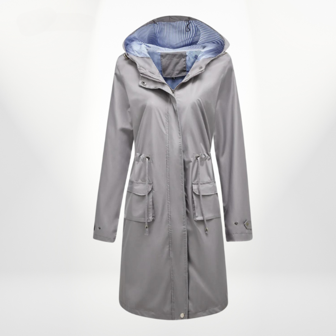 Modern women's hooded long rain jacket. Waterproof zip-up coat featuring a stylish drawstring waist for outdoor wear.