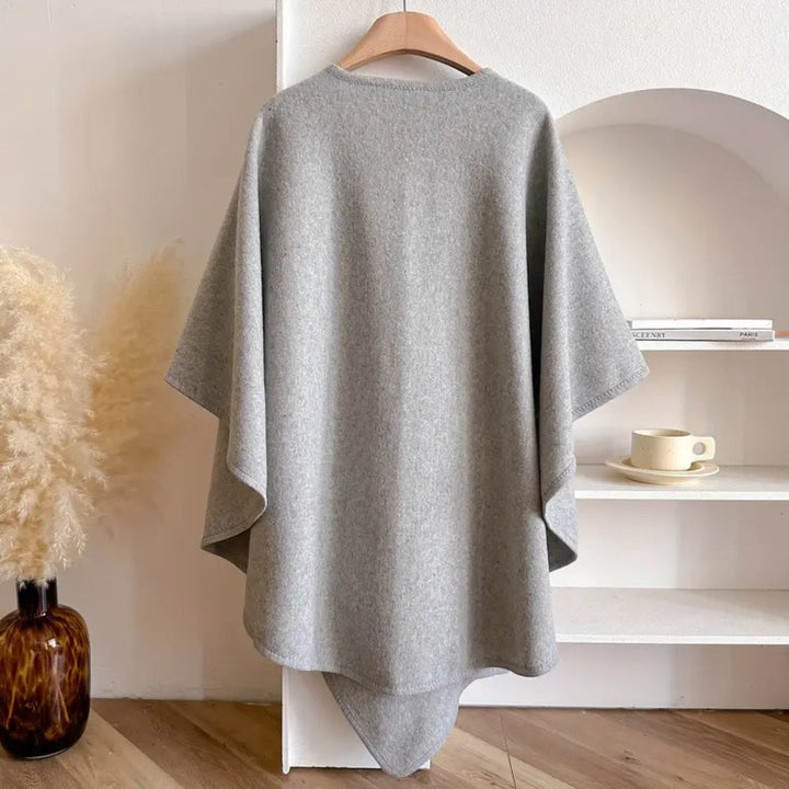 Chic women's windproof versatile cape poncho scarf coat. Cozy, elegant autumn/winter fashion accessory.