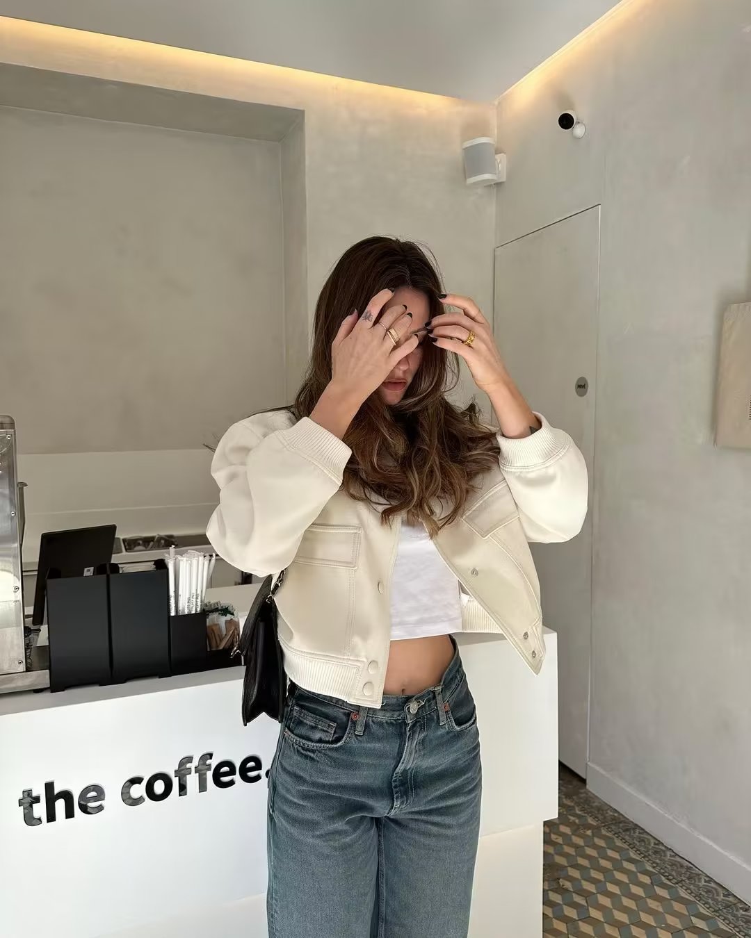 Fashionable women's cropped bomber jacket with utility pockets, ideal for everyday wear.