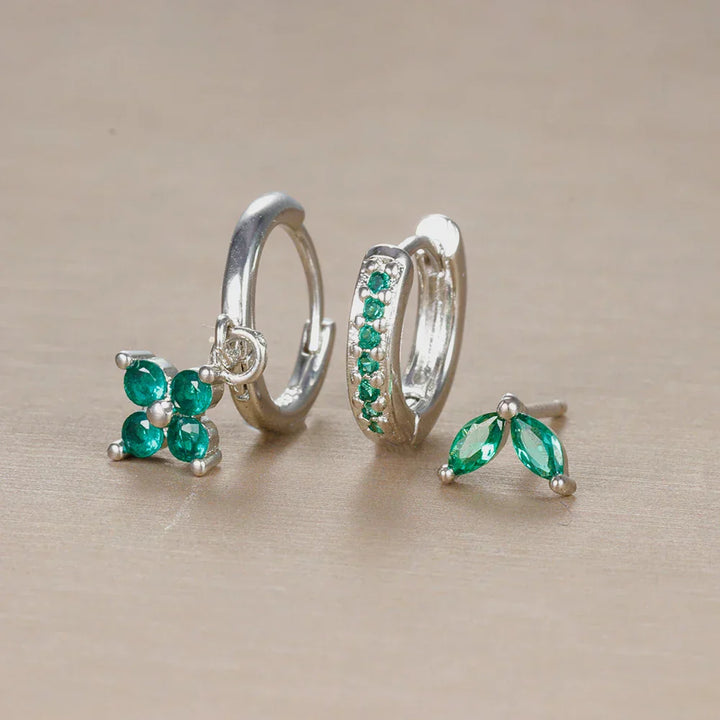 Silver tone minimalist piercing set for women, with hypoallergenic stainless steel studs & hoops for ear styling.