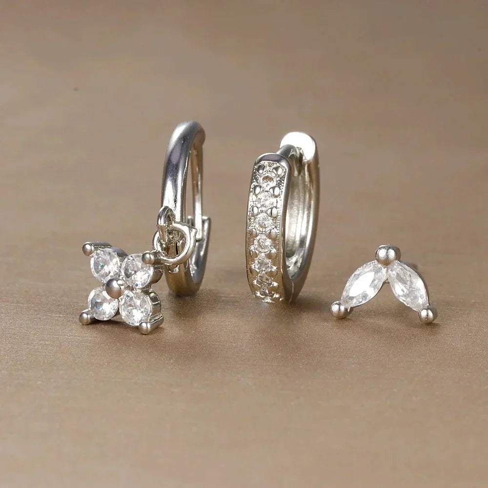 Hypoallergenic women's piercing set: stainless steel minimalist studs & hoops, ideal for sensitive skin & all-day comfort.