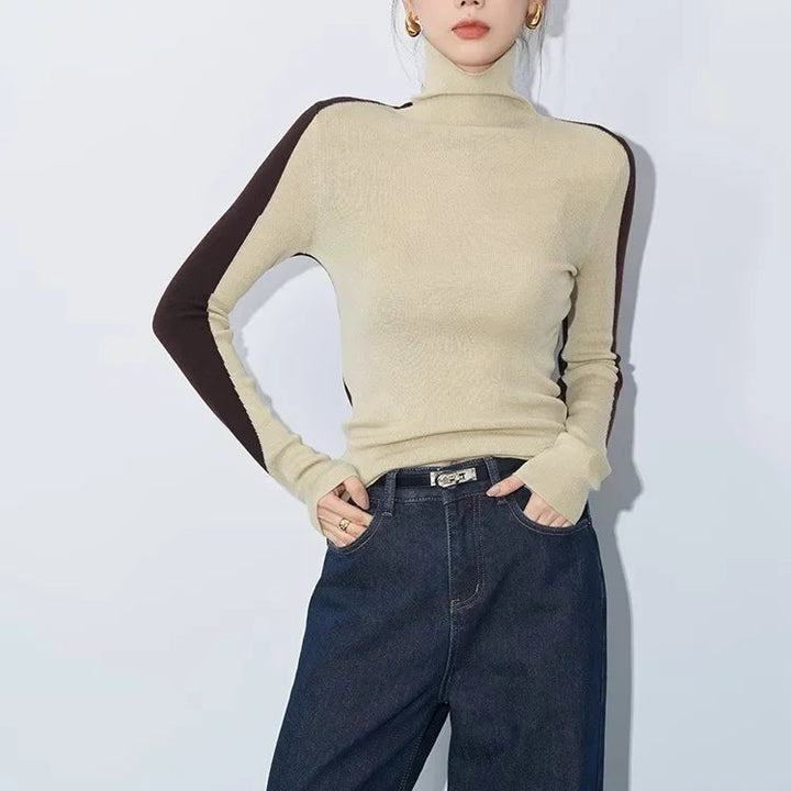 Women's mock neck sweater with contrast long sleeves and asymmetric design for a modern, stylish look.