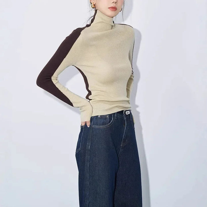 Stylish women's fall/winter mock neck top featuring long contrast sleeves & an asymmetric hem for casual chic.