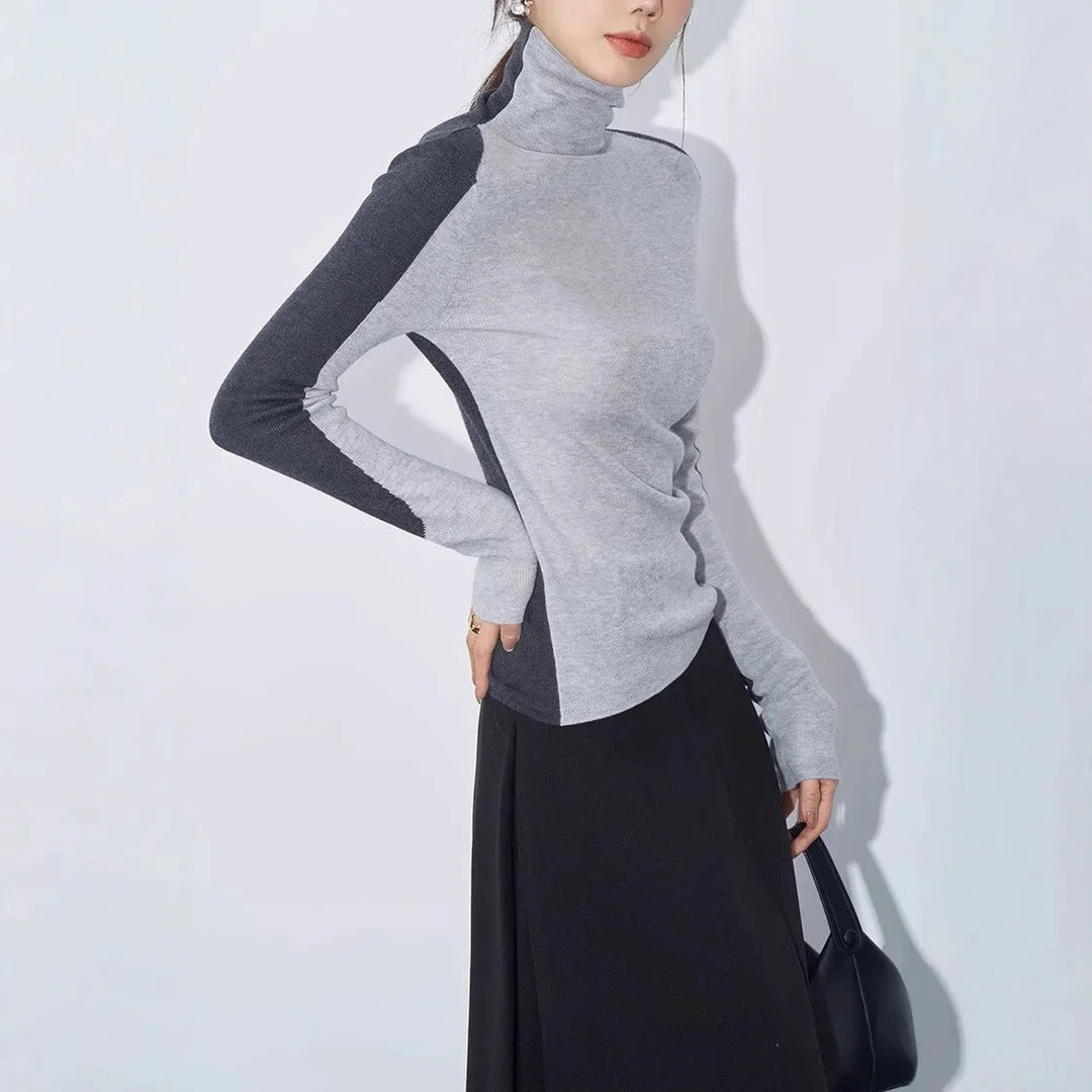 Chic women's mock neck sweater, long contrast sleeves, and asymmetric hem detail. Perfect for everyday style.