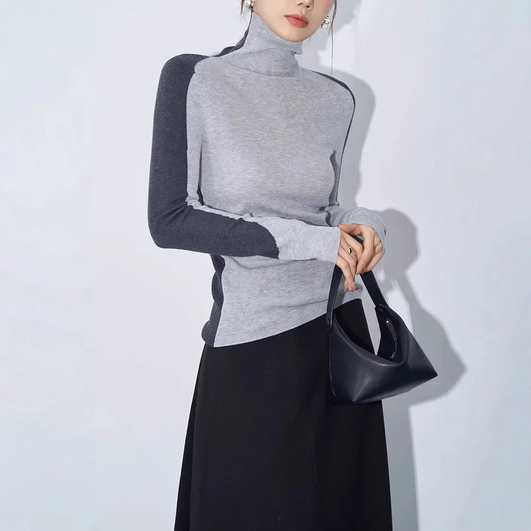 Women's unique mock neck top with asymmetric cut and bold contrast long sleeves. A modern, stylish sweater.
