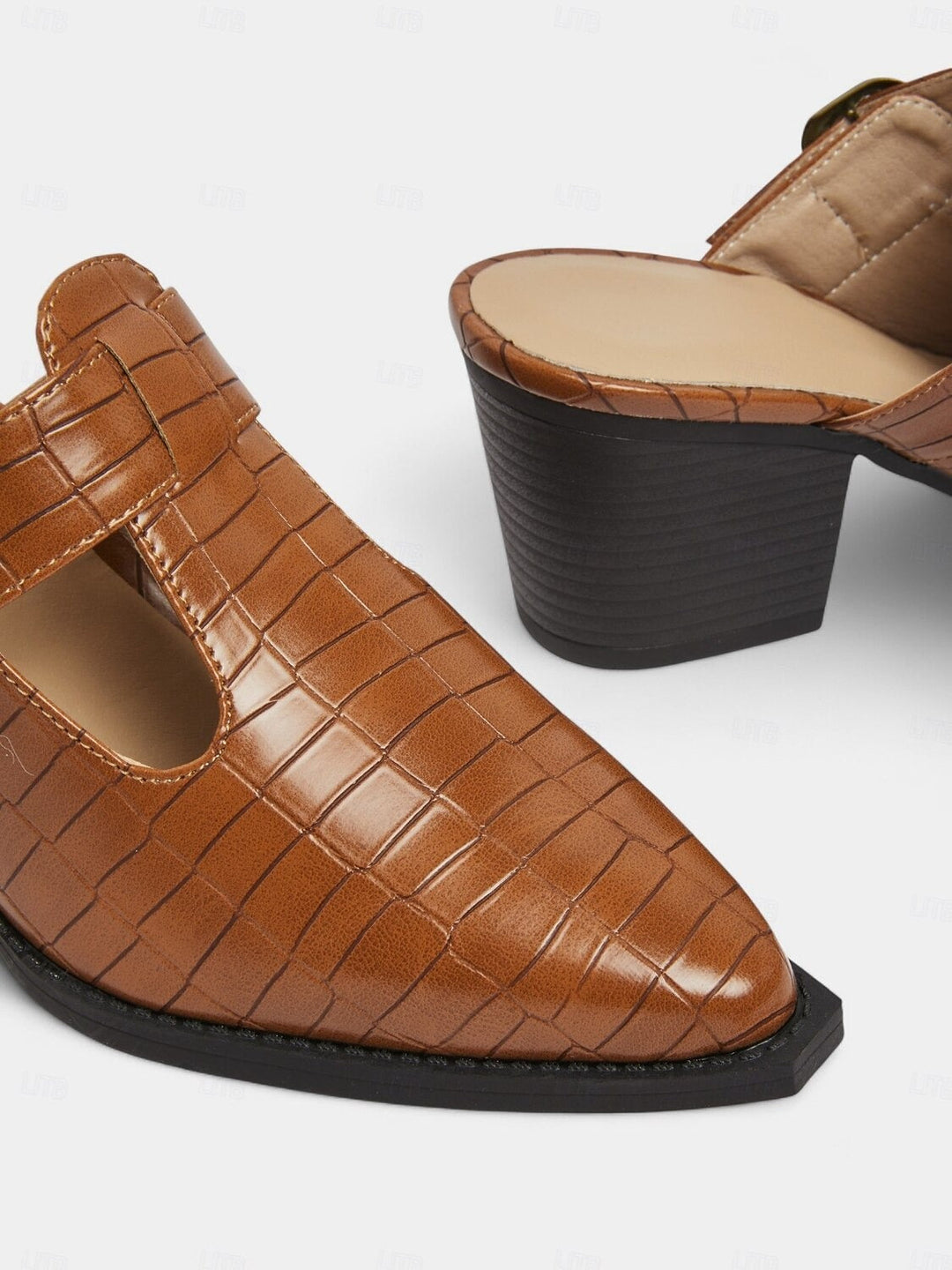Modern women's mules with a comfortable block heel, decorative buckle, and unique cut-out details. Slip-on chic.