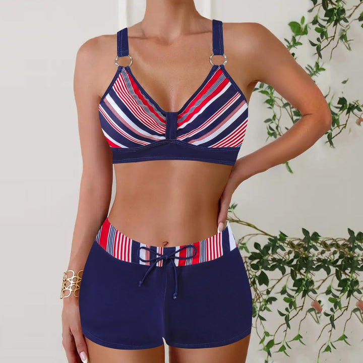 Woman wearing a chic nautical two-piece swim set, ready for beach days & summer vacation. Comfortable bikini style.
