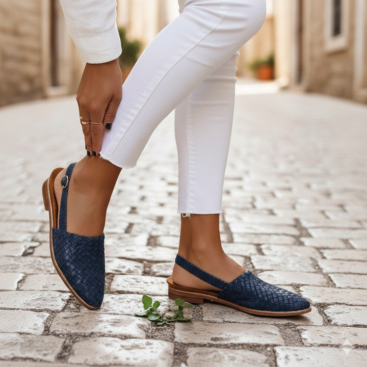 Close-up of elegant navy women's woven flats. Cushioned slip-on loafers for comfortable everyday style.