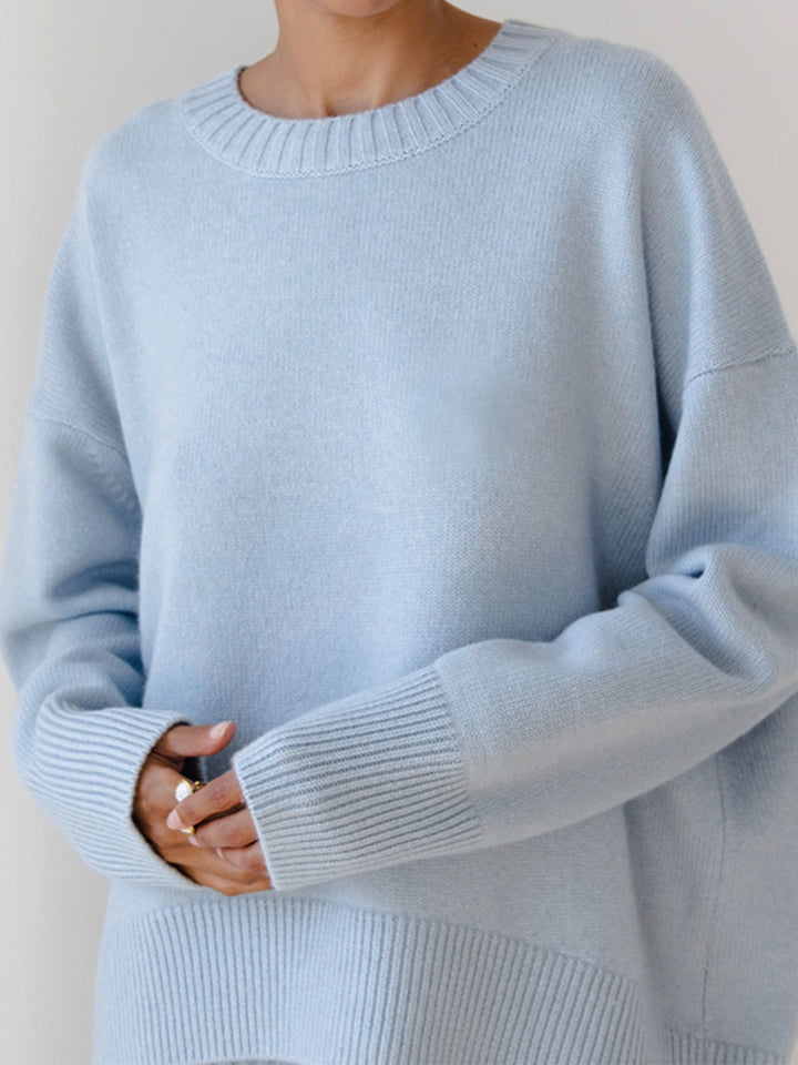 Black women's oversized crewneck knit sweater. Versatile, casual long sleeve top for everyday wear.