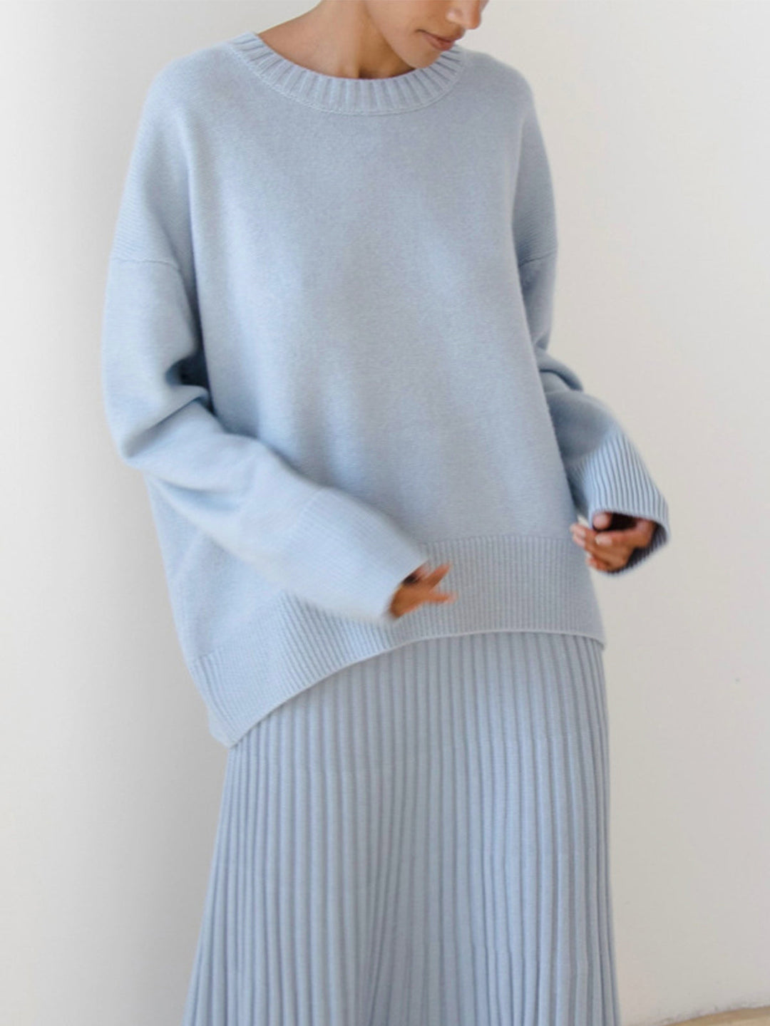 Grey oversized knit crewneck sweater for women. Comfortable, relaxed fit, essential for winter style.