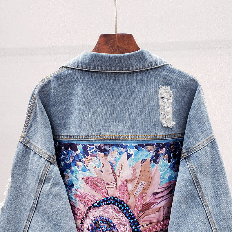 Stylish oversized women's denim jacket featuring a unique back print, ideal for versatile spring & fall fashion.