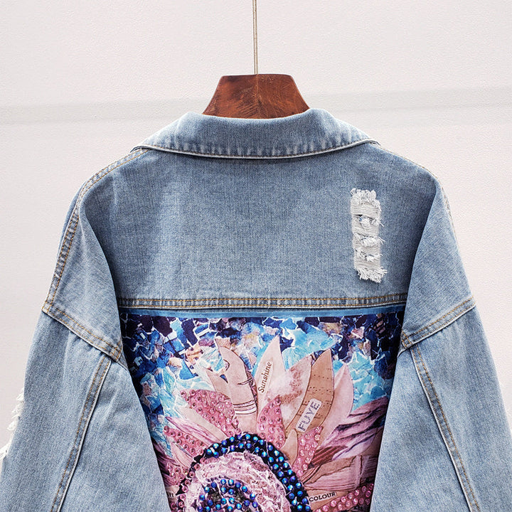 Stylish oversized women's denim jacket featuring a unique back print, ideal for versatile spring & fall fashion.