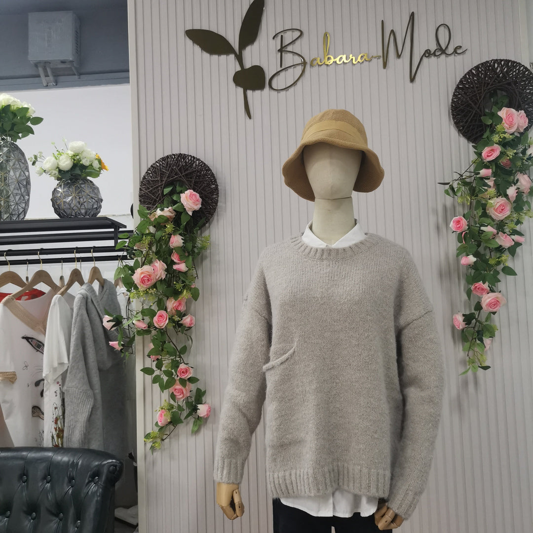Front view of a women's oversized knitted jumper, showcasing its cozy texture and relaxed fit.