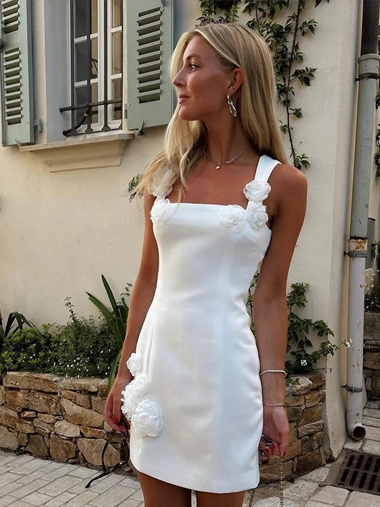 Woman modeling a stunning pink floral appliqué short dress, ideal for summer garden parties.
