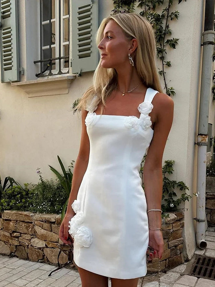 Woman modeling a stunning pink floral appliqué short dress, ideal for summer garden parties.